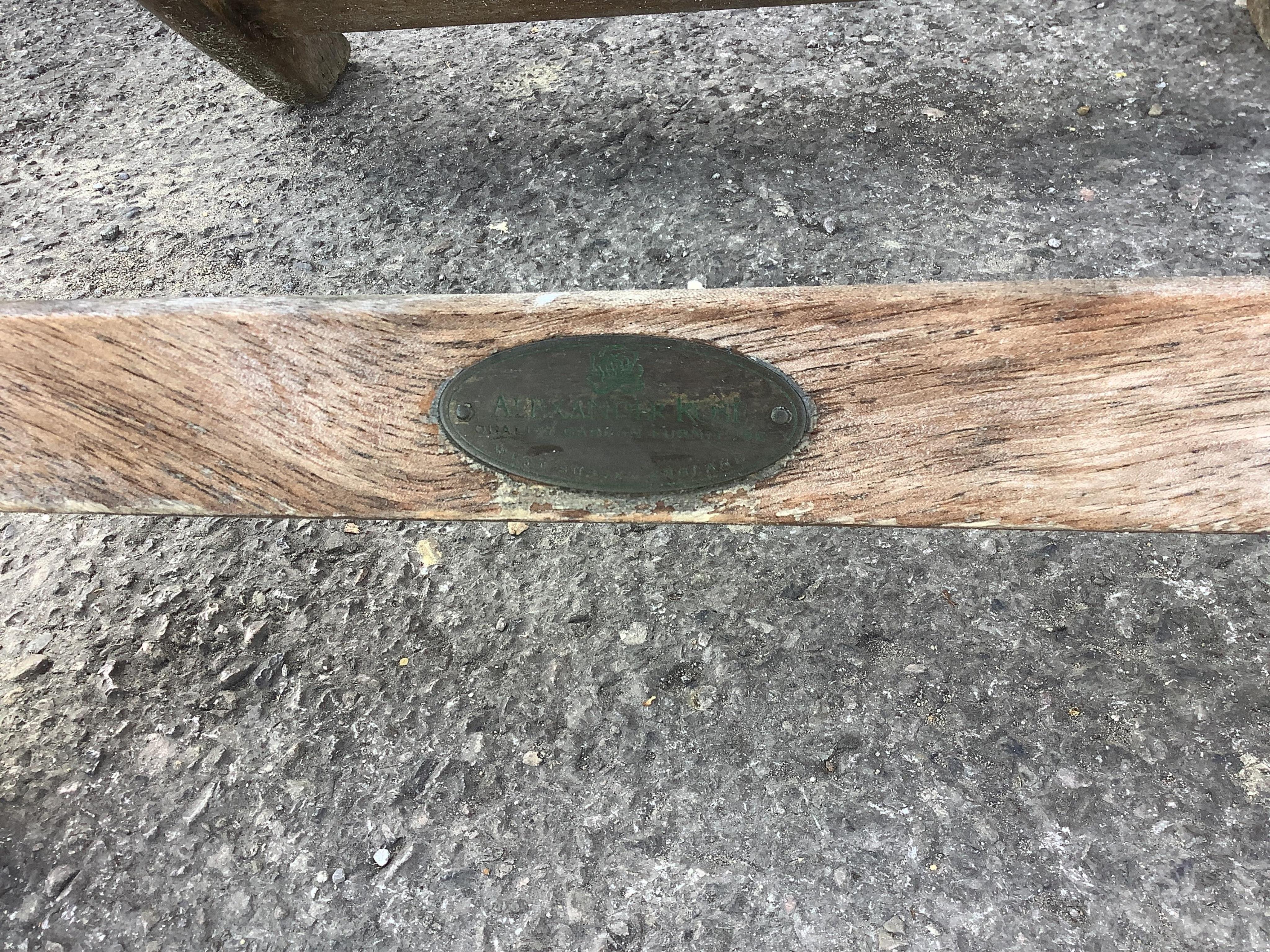 A weathered slatted teak Nova extending garden table, width 240cm extended, depth 100cm, height 71cm and six teak Alexander Rose folding chairs